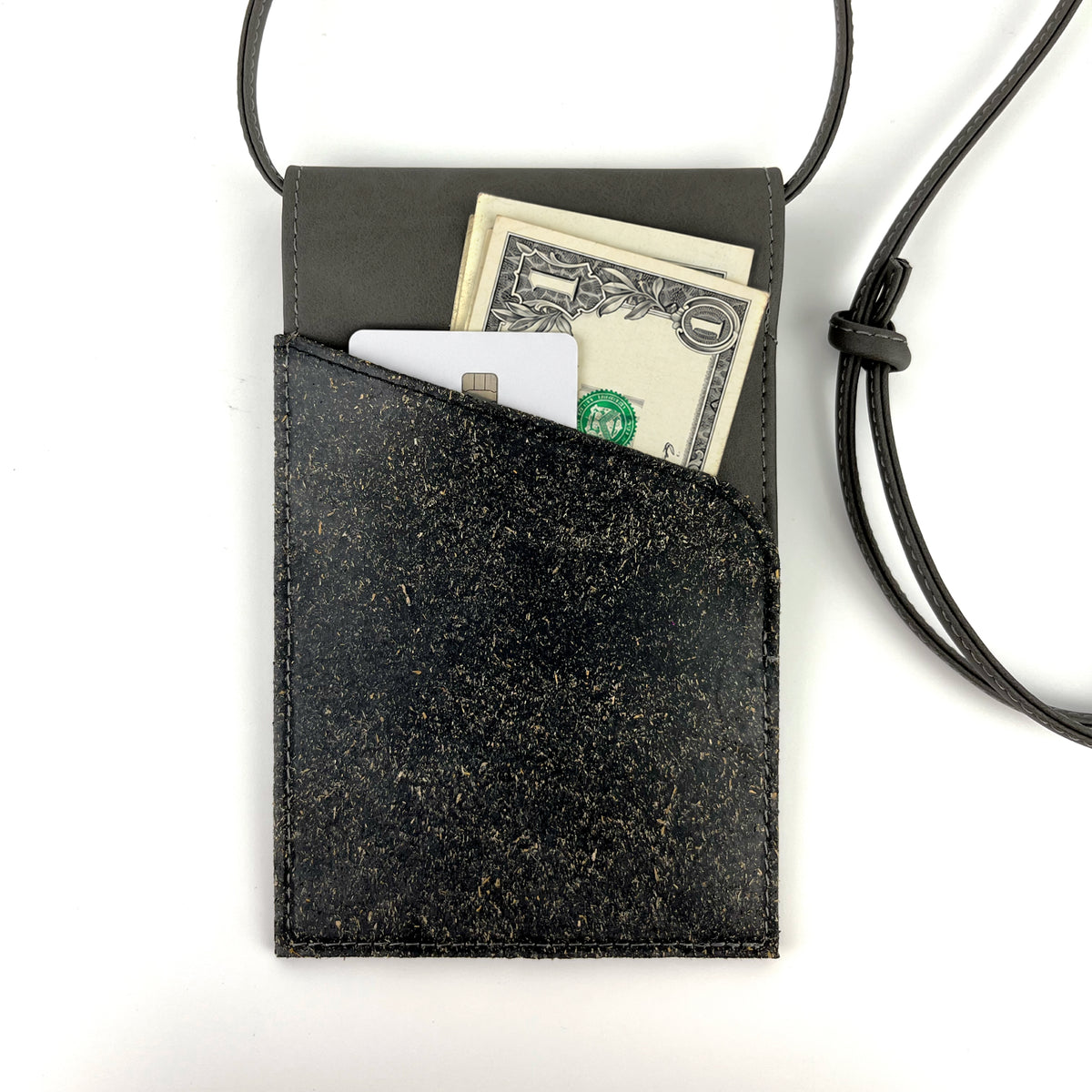 A black textured (banana) plant-based leather crossbody wallet with a black cord strap, shown on a white background with cash and cards partially inserted into the front pocket.
