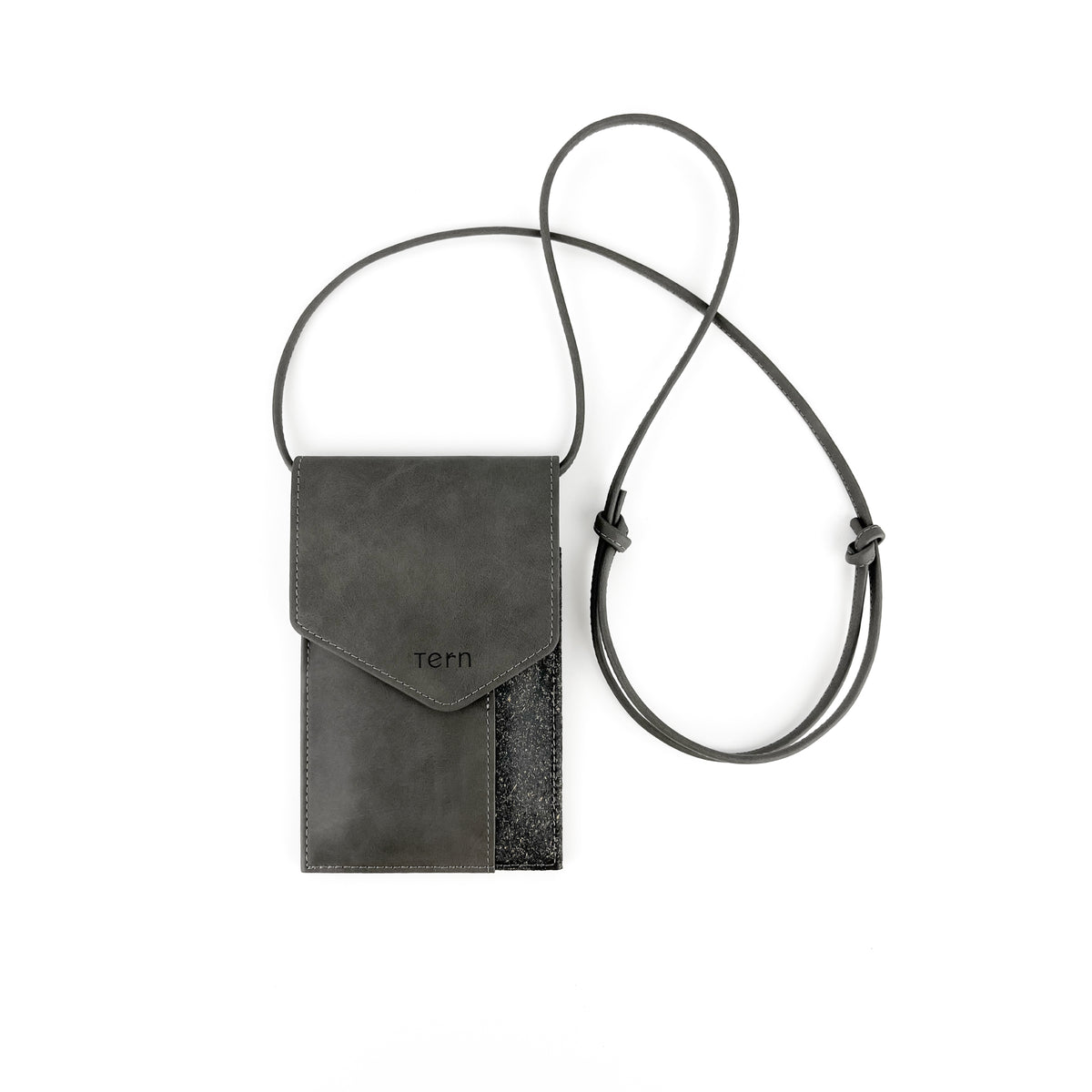 A grey and textured black plant-based leather crossbody phone pouch with a magnetic flap closure and a thin adjustable strap, shown on a plain white background. The brand name 'tern' is debossed on the front.
