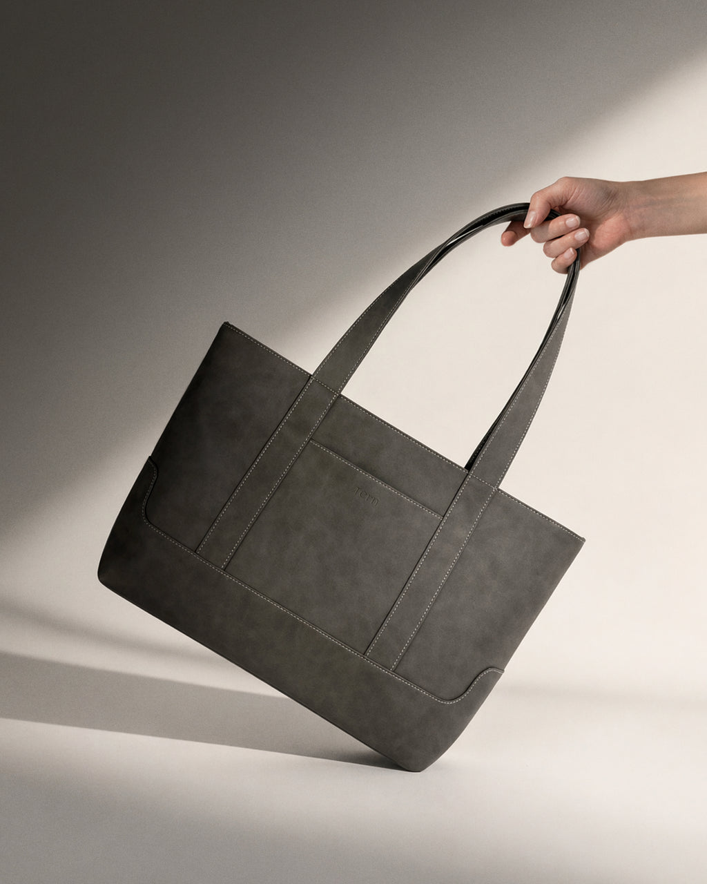 Tern Toku M plant-based leather compact tote bag in solid grey. Lightweight