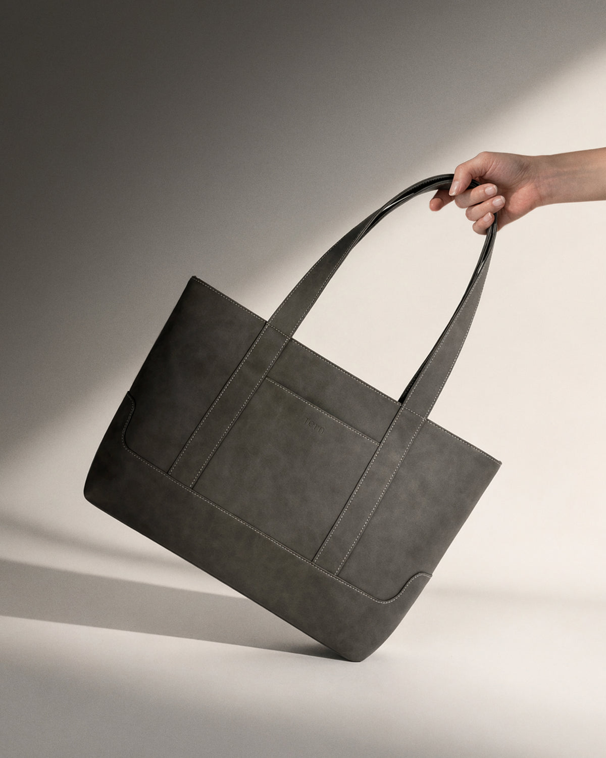 Tern Toku M plant-based leather compact tote bag in solid grey. Lightweight